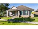 One-story home with a welcoming front porch and landscaped yard at 8794 Sidley Ln, Orlando, FL 32832