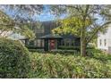 Charming two-story house with a red door, surrounded by lush greenery at 706 E Pine St # 5, Orlando, FL 32801