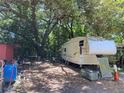 Area with RV parked, surrounded by trees and debris at 780 Snow Hill Rd, Geneva, FL 32732