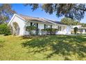 Side view of the house showcasing the landscaping at 1626 New Abbey Ave, Leesburg, FL 34788