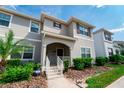 Two-story townhome with gray siding and landscaping at 4822 Lullaby Ln, Kissimmee, FL 34746