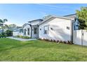 White modern home with gray accents, manicured lawn, and paved walkway at 1333 W Smith St, Orlando, FL 32804