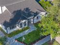 Modern home with a gray roof, paved driveway, and lush green lawn at 1333 W Smith St, Orlando, FL 32804