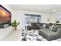 Spacious living room with large sectional sofa and TV at 287 Jetty Way, Davenport, FL 33897