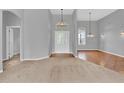 Spacious living room with neutral-toned carpet and tile flooring at 4538 Nottoway Dr, Leesburg, FL 34748