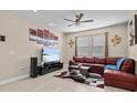 Spacious living room with a large sectional sofa and wall-mounted TV at 528 Bellissimo Pl, Howey In The Hills, FL 34737