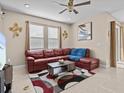 Relaxing living room featuring a comfortable sectional sofa and stylish decor at 528 Bellissimo Pl, Howey In The Hills, FL 34737
