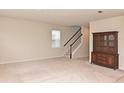 Large living room with carpeted floors and wooden cabinet at 17608 Saw Palmetto Ave, Clermont, FL 34714