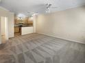 Spacious living room with neutral carpeting and open concept kitchen at 1711 Shadow View Cir # 1711, Maitland, FL 32751