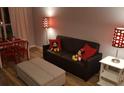 Mickey Mouse themed living room with a sofa and ottoman at 3100 Parkway Blvd # 748, Kissimmee, FL 34747