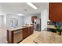 Island kitchen features stainless steel appliances and granite countertops at 356 Nova Dr, Davenport, FL 33837