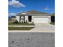 One-story house with gray siding, dark brown accents, and a two-car garage at 564 Boardwalk Ave, Haines City, FL 33844