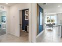 Modern entryway with a blue accent wall, storage, and access to other rooms at 1006 Tupelo Trl, Haines City, FL 33844