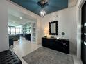 Elegant entryway with modern console table and statement mirror at 331 Muirfield Loop, Reunion, FL 34747