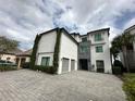 Contemporary three-story house with stone accents at 331 Muirfield Loop, Reunion, FL 34747