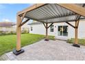 Covered patio with a wooden pergola and brick pavers at 13700 Sw 38Th Ct, Ocala, FL 34473