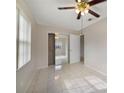 Bright bedroom with mirrored closet doors and tile flooring at 793 E Birchwood Cir, Kissimmee, FL 34743