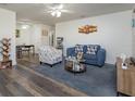 Living room with blue sofa and wood-look floors at 453 D St # 4, Casselberry, FL 32707