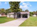 House exterior showcasing a carport and well-maintained lawn at 30 Seminole Dr, Debary, FL 32713