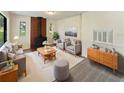 Living room featuring a fireplace and mid-century modern furniture at 303 Carleton St, Lakeland, FL 33803