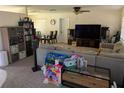 Gathering-friendly living room with sectional sofa, TV, and toys at 1301 Redwood Ct, Tavares, FL 32778
