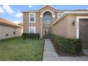 Two-story house with brown exterior, walkway, and landscaping at 6844 Pomeroy Cir, Orlando, FL 32810