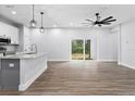 Open living space with kitchen island and sliding glass doors at 405 N Mcdonald Ave, Deland, FL 32724