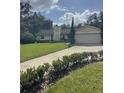 House exterior showcasing landscaping and a two-car garage at 10556 Park Ridge Gotha Rd, Windermere, FL 34786