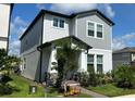 Two-story house with gray siding, stone accents, and a welcoming porch at 12500 Encore At Ovation Way, Winter Garden, FL 34787
