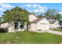 One-story home with a two-car garage and landscaped lawn at 436 Copperstone Cir, Casselberry, FL 32707