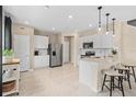 Modern kitchen with white cabinets, stainless steel appliances, and an island at 4511 Cypress Cay Way, Kissimmee, FL 34746