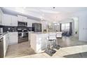 Modern kitchen with stainless steel appliances and an island at 3191 Paradox Cir # 406, Kissimmee, FL 34746