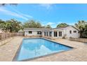 Inviting rectangular pool with a large patio area and privacy fence at 118 Lea Ave, Longwood, FL 32750