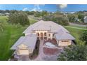 An aerial view showcasing the house, landscaping, and surrounding neighborhood at 38748 Lakeview Walk, Lady Lake, FL 32159