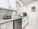 White shaker cabinets, granite countertops, and stainless steel appliances at 2809 Almaton Loop # 304, Kissimmee, FL 34747
