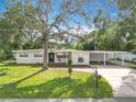 Newly renovated home with a modern exterior and a spacious lawn at 850 Land Ave, Longwood, FL 32750