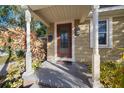 Inviting front porch with a wooden door and decorative light fixture at 1415 Virginia Dr, Orlando, FL 32803