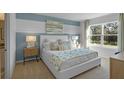 Main bedroom with light blue accent wall and comfortable bed at 4193 Singing Mockingbird Blvd, Bartow, FL 33830