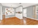 Hardwood floors, built-in white shelving, and a charming chandelier at 504 Osceola Ave, Eustis, FL 32726