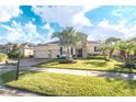 Two-story home with a three-car garage and palm trees at 1511 Alligator St, St Cloud, FL 34771