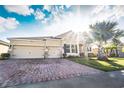 Two-story home with a three-car garage and a large driveway at 1511 Alligator St, St Cloud, FL 34771