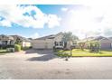 Two-story home with a three-car garage and a landscaped yard at 1511 Alligator St, St Cloud, FL 34771