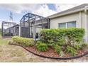 Landscaped backyard with a screened patio at 3825 Quaint Ln # F, Clermont, FL 34711