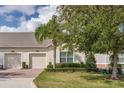 Two-story house with light-colored siding and two-car garage at 3825 Quaint Ln # F, Clermont, FL 34711