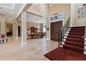 Grand two-story entryway with tile floors and a sweeping staircase at 9632 Weatherstone Ct, Windermere, FL 34786