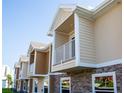 Tan and brown multi-Gathering building with balconies at 107 Oceans Cir, Daytona Beach Shores, FL 32118
