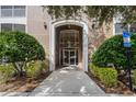 Attractive building entrance with landscaping at 3356 Robert Trent Jones Dr # 101, Orlando, FL 32835