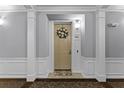 Inviting condo entryway with decorative wreath and neutral color palette at 3356 Robert Trent Jones Dr # 101, Orlando, FL 32835