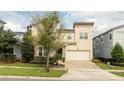 Two-story house with stone accents and a two-car garage at 9043 Sunshine Ridge Loop, Kissimmee, FL 34747