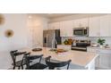 Modern kitchen with stainless steel appliances and an island with seating at 5736 Le Marin Way, Kissimmee, FL 34758